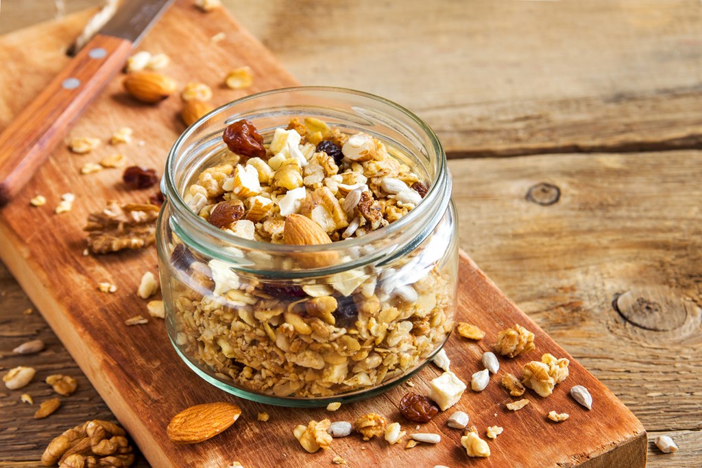 Homemade granola with nuts and seeds in glass jar